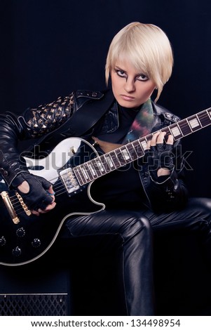 Beautiful blonde girl with electric guitar
