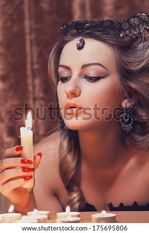 Wonderful woman with a candle in a hand