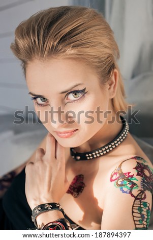 Beautiful blond woman with henna tattoo