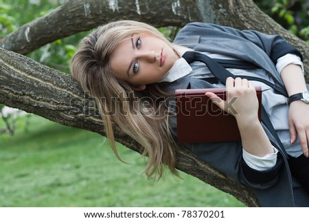 Girl with a book in a spring garden