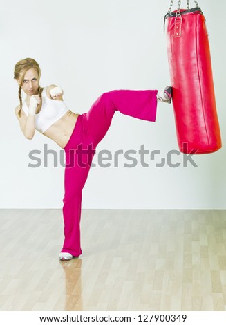 Fitness middle age Woman doing high kick.