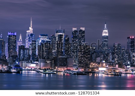 New York City Manhattan skyline panorama at night over Hudson River