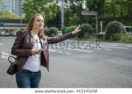 Young White Female Hailing Taxi