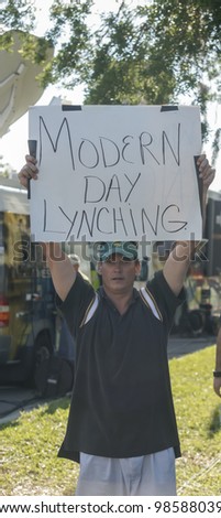 SANFORD, FL-MARCH 26: A protester holds a sign in support of Trayvon Martin on March 26, 2012 in Sanford Florida. Trayvon Martin was shot and killed by George Zimmerman on February 26 2012, he was 17.