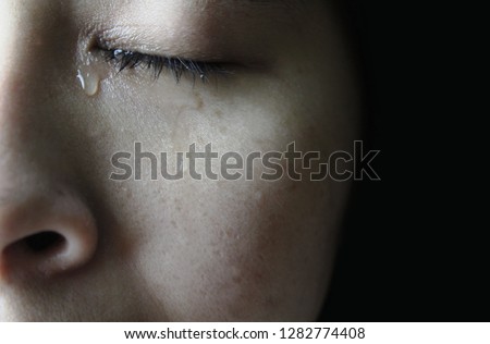 Close up eye of Asian woman crying with tears