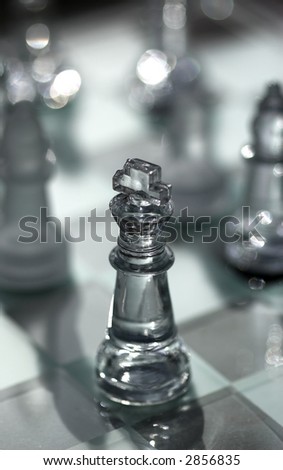 Glass chess pieces in strong light