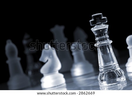 Glass chess pieces in strong light