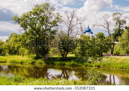 Landscape with the river and trees on the background of the Suzdal Kremlin, Russia. Golden Ring of Russia