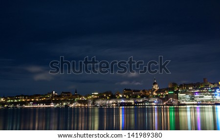 Stockholm cityscape at night with light reflection in water