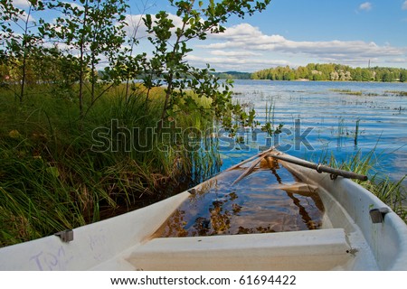 Sink boat on lake shore in Finland