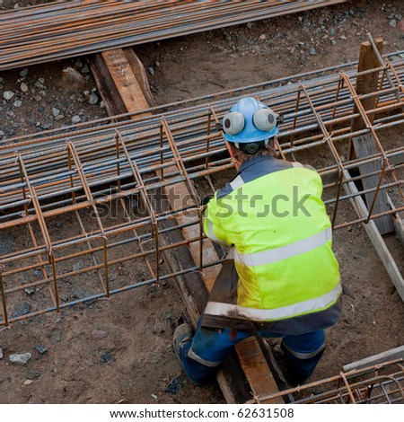 Construction working assemble iron grids into the frame ready for concrete work