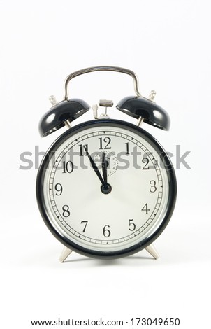 Old Alarm Clock isolated on white background, showing five to twelve  o\'clock