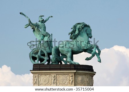 Sculpture of a male figure driving a chariot using a snake as a whip, representing war.