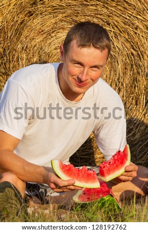 The person eats an outdoors sweet and tasty water-melon