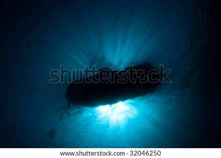 The Silhouete of a dive boat on a mooring line. Red Sea, Egypt.