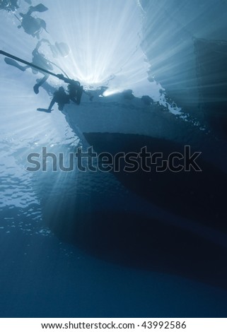 Silhouette shot of scuba divers at the bow of a dive boat. Red Sea, Egypt.