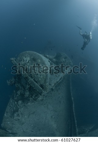 Scuba divers over the starboard side water tank wagon on the deck of the world war two shipwreck The SS Thistlegorm. Red Sea, Egypt