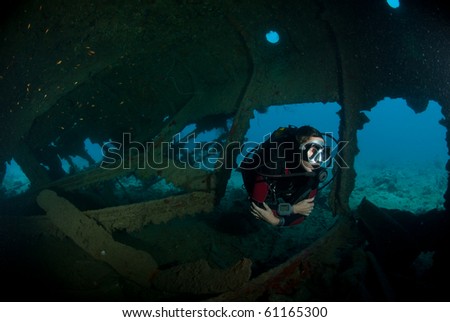 A female scuba diver exploring the inside of the SS Dunraven shipwreck. Beacon rock, Ras Mohammed national Park, Red Sea, Egypt.