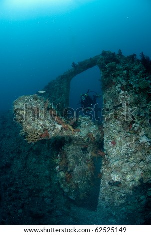 A female scuba diver exploring the stern of the SS Dunraven. Beacon rock, Ras Mohammed national Park, Red Sea, Egypt.