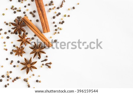 Star anise, cinnamon sticks, cloves and pepper on a white background