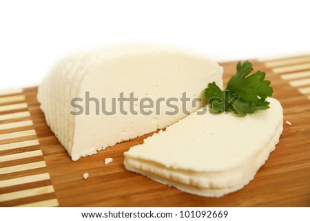 sliced white goat cheese on wooden plate