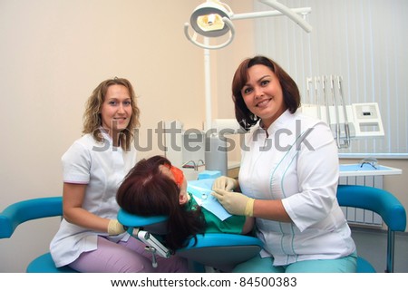 Young female patient takes a dental attendance in the dentist's office.