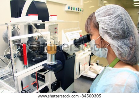 Young female doctor working with a microscope in a laboratory