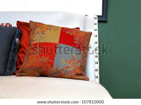 Decorative floral pattern pillow on white chair