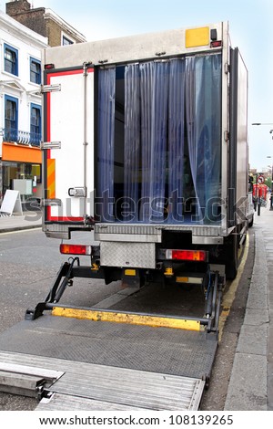 Open back door of delivery truck parked on street