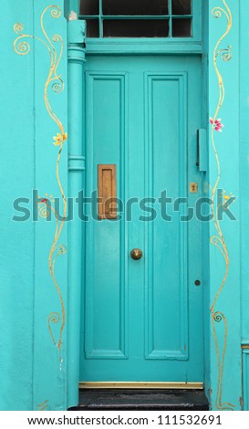 Blue entrance door in front of residential house