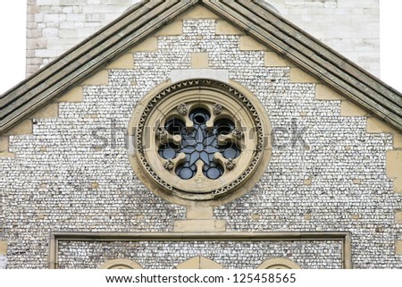 Detail of old medieval church facade with oval window