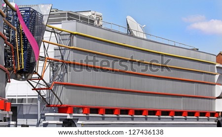 Modern architecture building used as information center with large satellite antenna