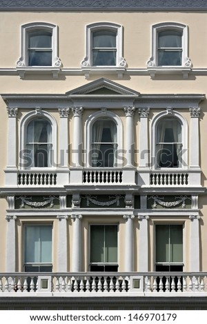 Old white facade building with windows and balconies