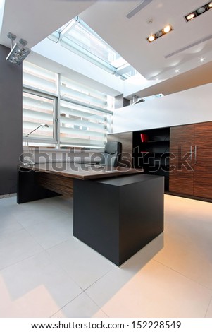 Private office interior with large window and modern furniture