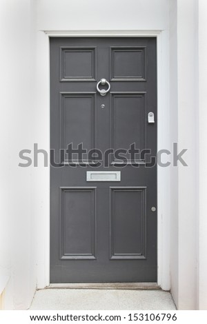 Gray entrance door to front of residential house