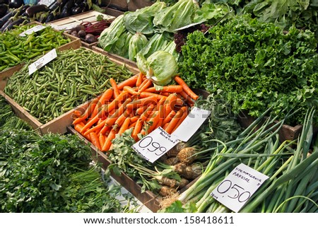 Organic green vegetables sold on market stall