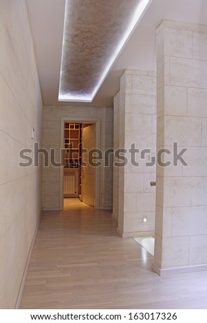 Long corridor in luxury house interior leading towards walk in closet
