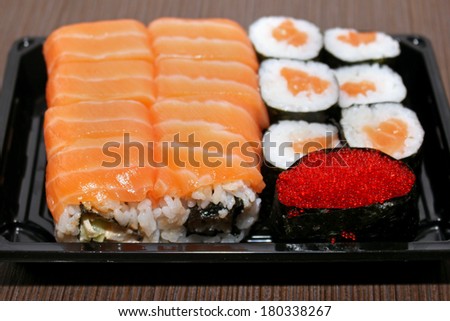 Assortment of fresh sushi on plastic plate