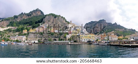 POSITANO, ITALY - June 28; Famous Italian summer seaside spot on Amalfi coast in Positano, Italy - June 28, 2014; Panoramic image of Amalfi coast with Mediterranean architecture and tourists on dock