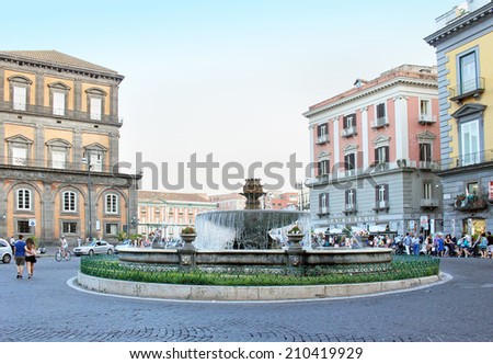 NAPLES, ITALY - June 21; Famous Piazza Trieste e Trento with fountain in center of the square in Naples, Italy - June 21, 2014; Busy square Trieste e Trento with Artichoke Fountain at the center