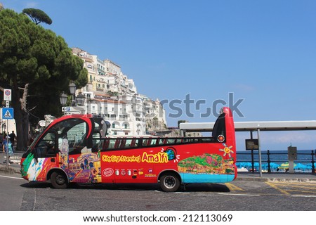 AMALFI, ITALY - June 27; Touristic City Sight Seeing bus with open top on in Amalfi, Italy - June 27, 2014; Traditional sightseeing bus with open top on street of Amalfi coast waiting for tourists