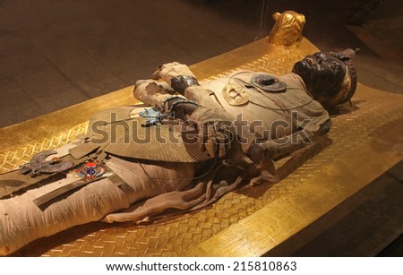 CAIRO, EGYPT - FEBRUARY 26; Ancient mummy in Egyptian village tourist attraction near Cairo, Egypt - February 26, 2010; Mummy style body show cased as tourist attraction among other old artifacts.