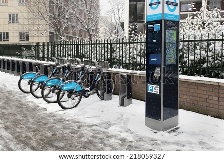 LONDON, UK - January 20; Cycle hire scheme founded by Boris Johnson mayor of London and Barclays in London, UK - January 20, 2013; Bicycles for hire on London sidewalk during winter season under snow