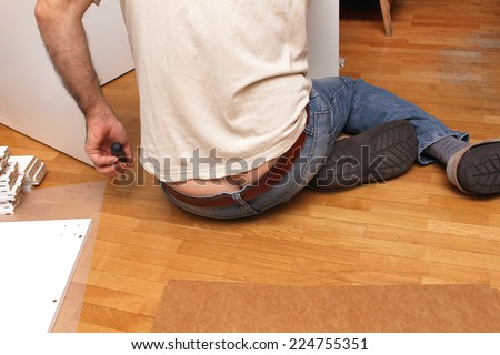 Repairman working inside home interior bending over and showing butt crack
