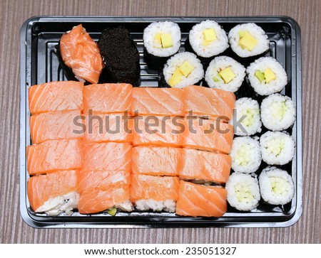 Fresh raw salmon sushi in plastic tray