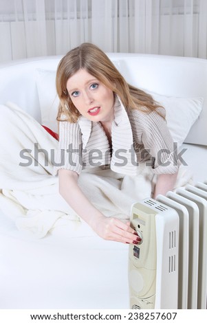 Keeping warm next to electric radiator turning it on inside home during cold weather