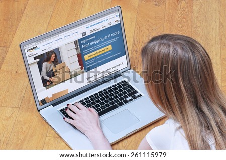 London, UK - February 06, 2015: Young woman signing up for Amazon Prime on online shopping site. Amazon Prime is paid service that gives Amazon shoppers free delivery and access to Prime Instant Video