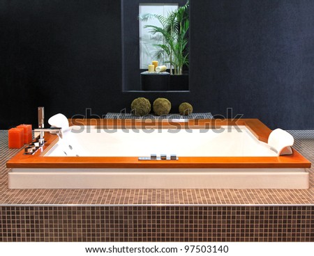 Square hydro-massage tub in modern bathroom interior