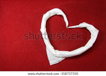 white tissue heart on red velvet