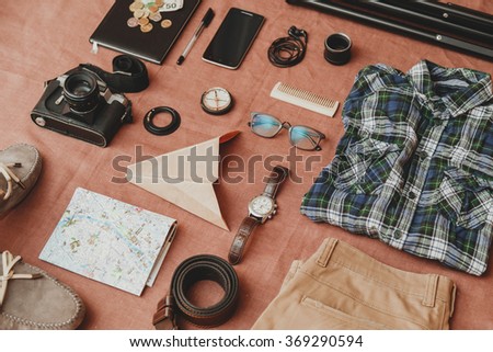 Trip concept - set of cool photography man stuff on linen cloth background